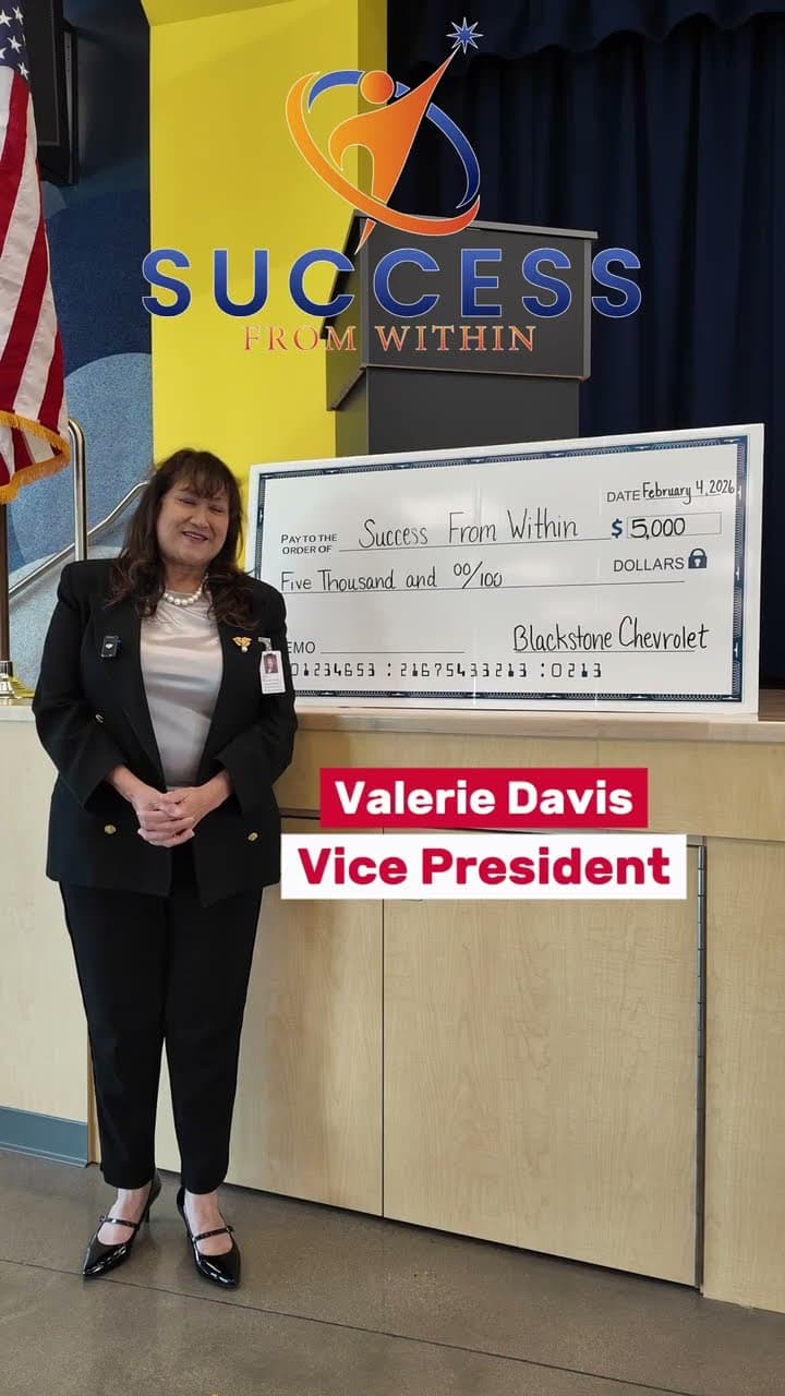 Valerie Davis beside a five thousand dollar cheque presented to Success From Within